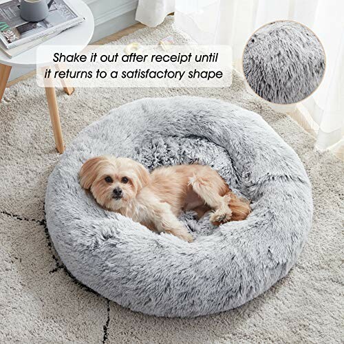 Small dog lying in a fluffy gray donut-shaped bed with a note about reshaping.