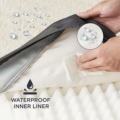 Hands showing waterproof mattress inner liner with water droplets.